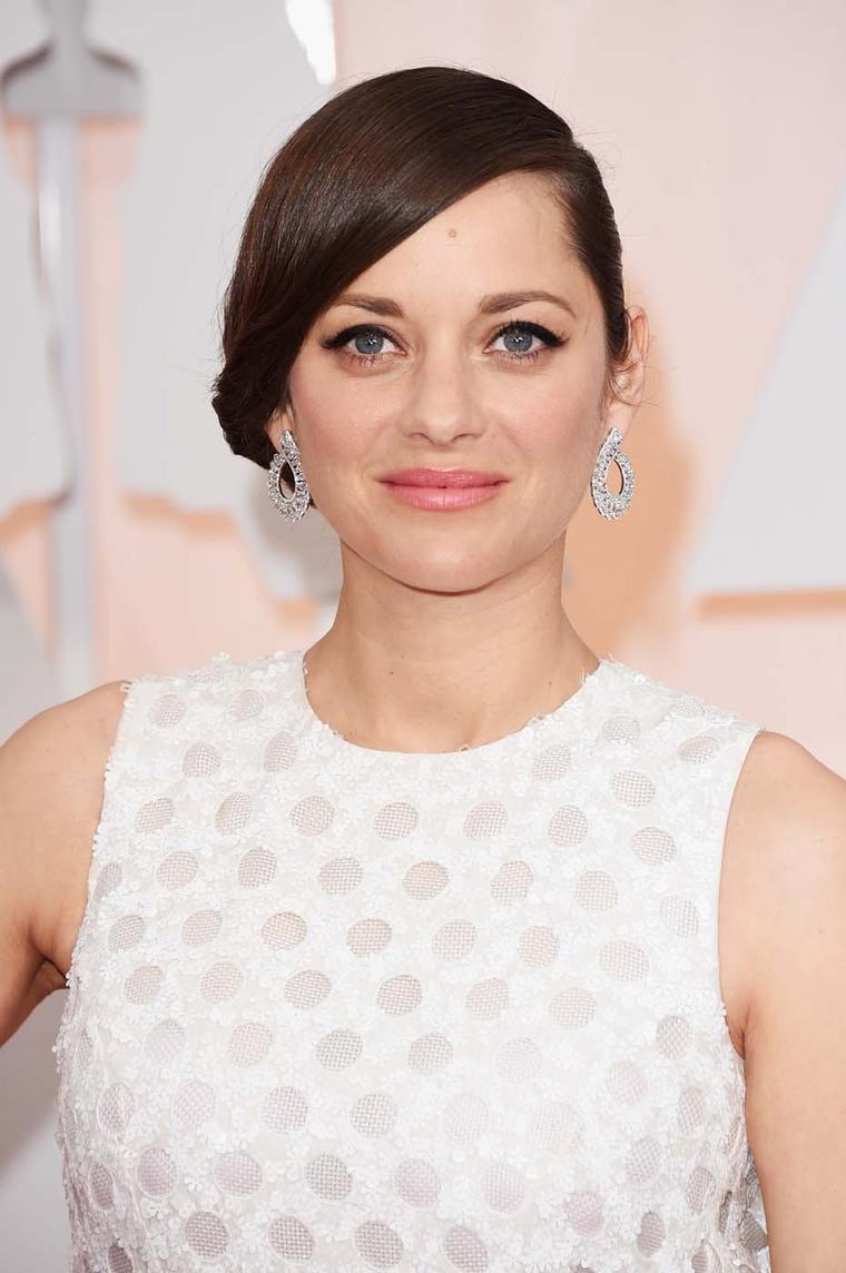 Best Actress nominee, Marion Cotillard chose a pair of sculptural diamond Chopard earrings to accessorize her opinion-dividing, polka dot-style Dior dress.